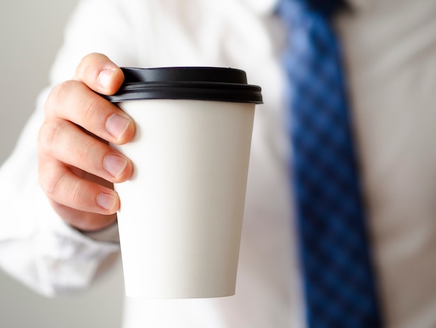 Close-up man holding coffee cup mock-up