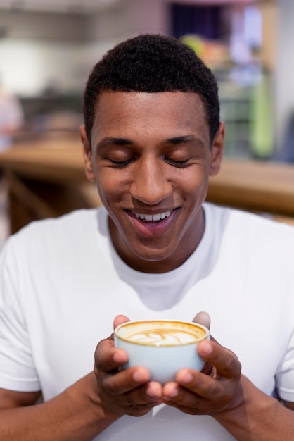 Close up man holding coffee cup