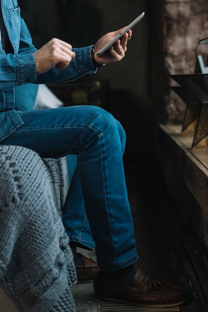 Close-up of man holding digital tablet