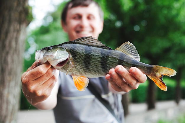 Close-up of man holding fresh caught fish