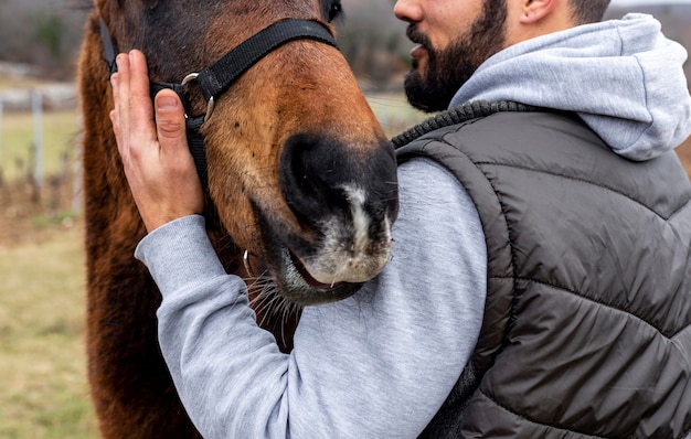 Free Photo close-up man holding horse