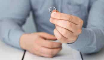 Free photo close-up man holding marriage ring