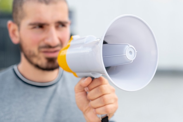 Close-up man holding megaphone 