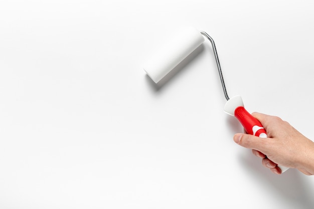 Close-up man holding a roller brush