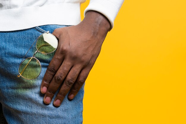 Close-up man holding sunglasses in pocket