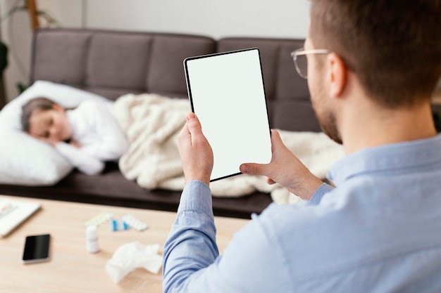 Free Photo close-up man holding tablet