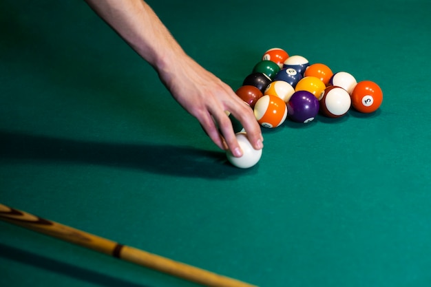 Free photo close-up man holding the white ball