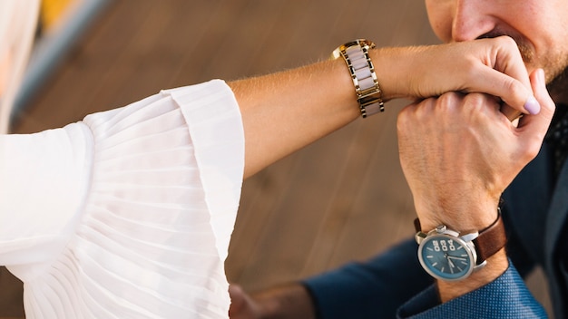 Close-up of man kissing on her girlfriend's hand