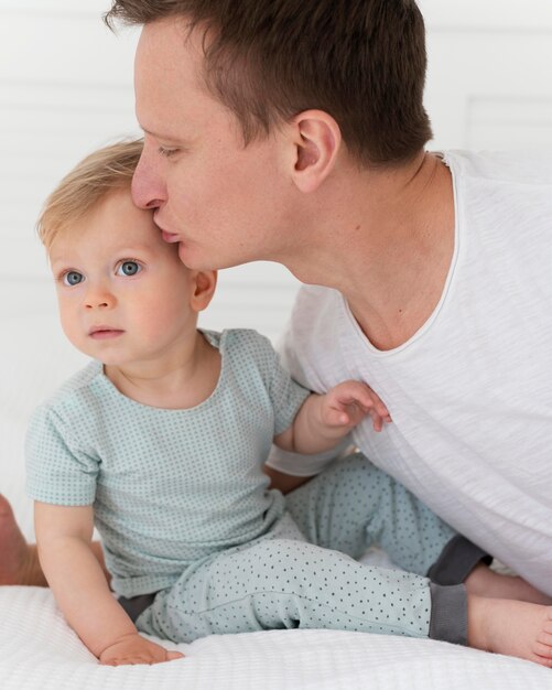 Close up man kissing toddler