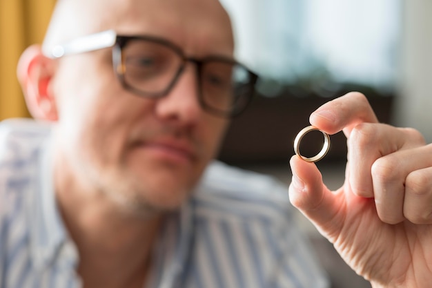 Free Photo close-up man looking at wedding ring