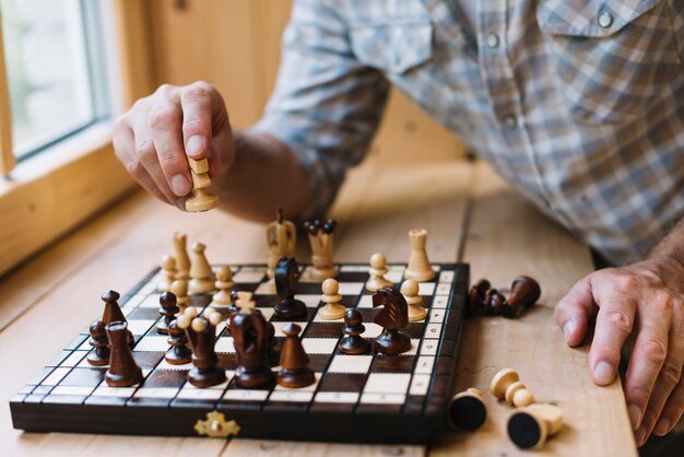 Close-up of man playing chess