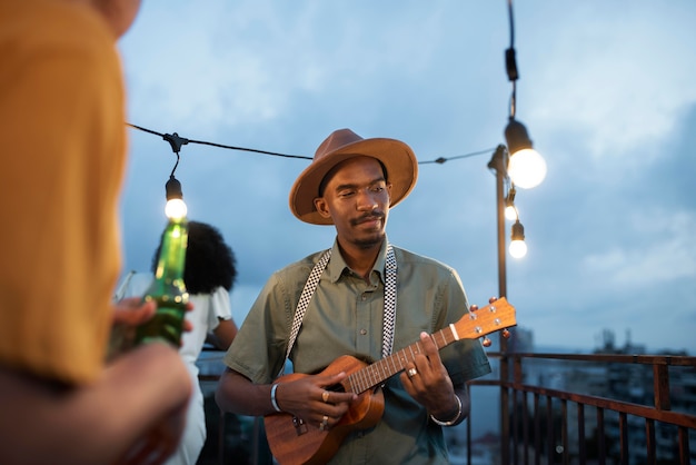 Free photo close up man playing the ukulele