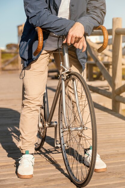 Close up man posing with bicycle