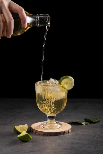 Close-up man pouring drink in a glass