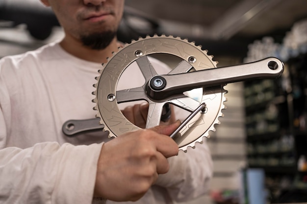 Free Photo close up man repairing bicycle