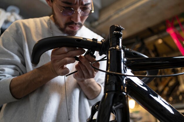 Close up man repairing bike