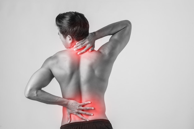 Free photo close up of man rubbing his painful back isolated on white background.