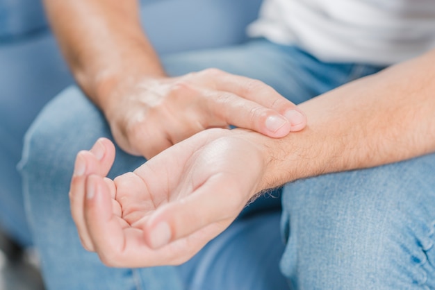 Free Photo close-up of a man's hand checking pulse