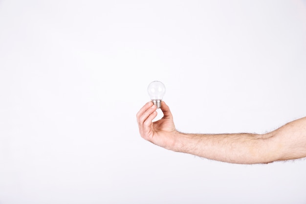 Close-up of a man's hand holding light bulb