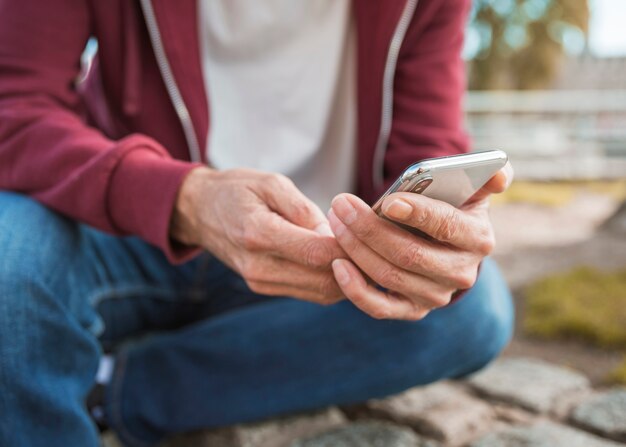 Close-up of man's hand holding smart phone in hand