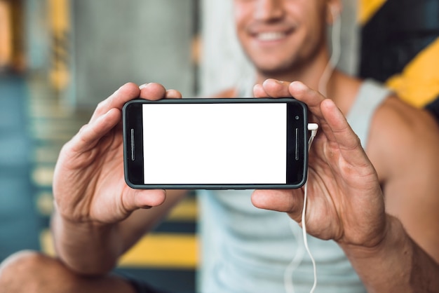 Close-up of a man's hand showing cellphone with blank white screen