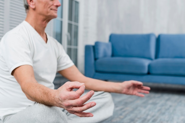 Close-up of man's hand with mudra gesture at home