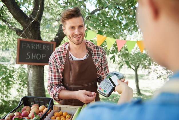 Free Photo close up on man selling crops from his garden