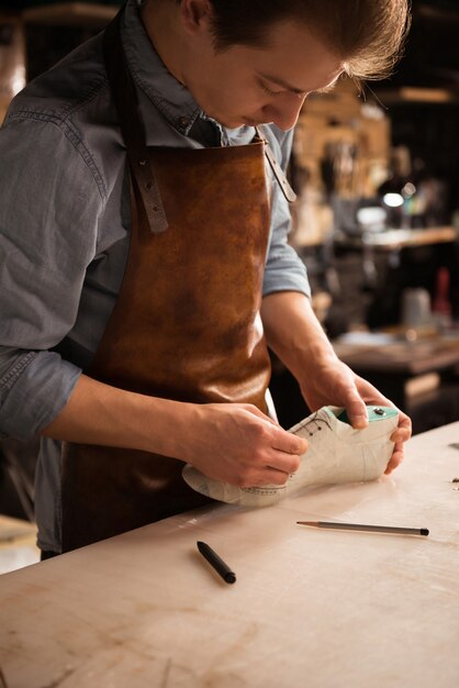 Close up of a man shoemaker working