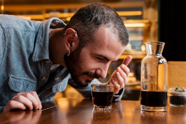 Free Photo close-up of man smelling cup of coffee