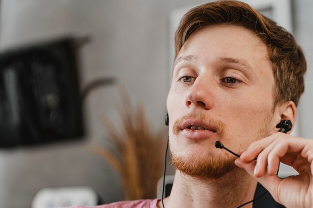 Close-up man streaming with earphones