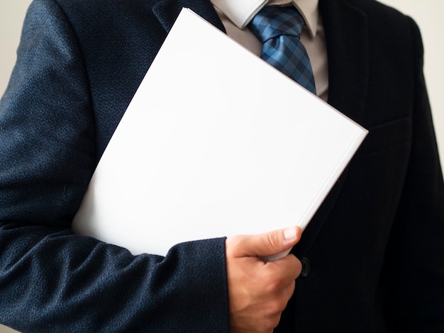 Free Photo close-up man in suit with notebook mock-up