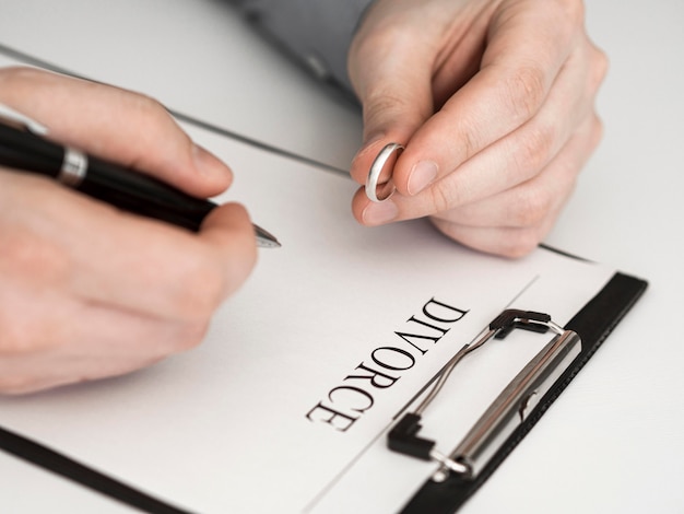 Close-up man thinking to sign divorce contract