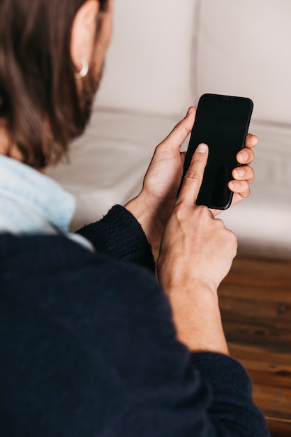 Free Photo close-up of a man touching her finger on touch screen mobile screen