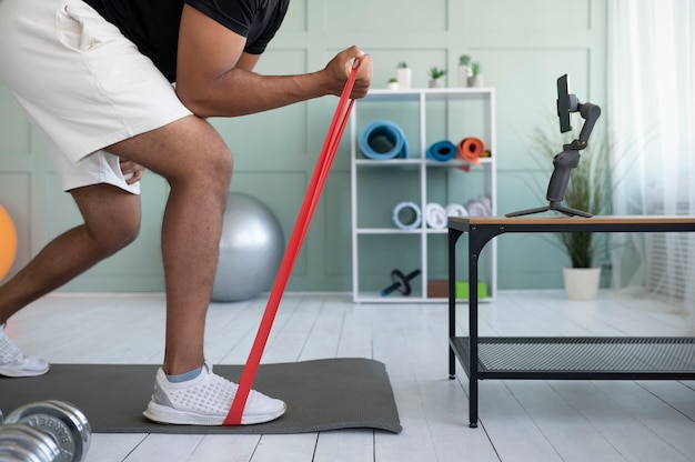 Close up man training with elastic band