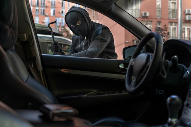 Close up on man trying to break into a car