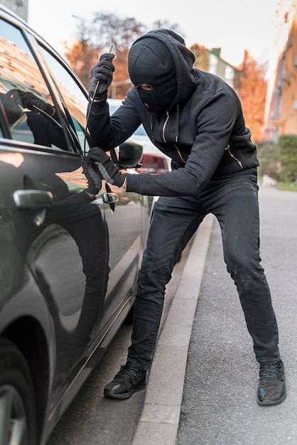 Close up on man trying to break into a car