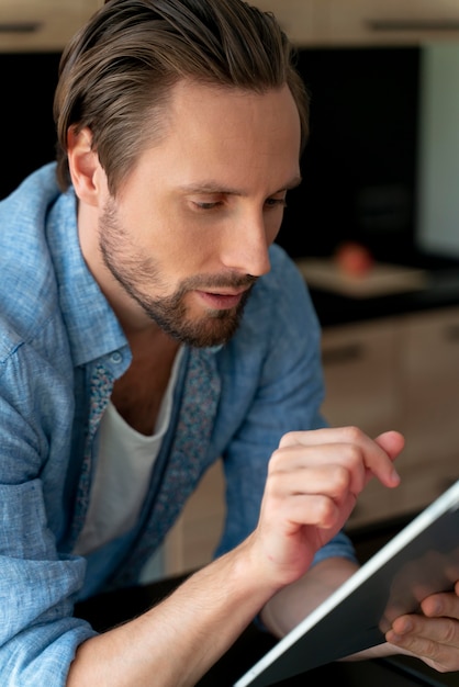 Close up on man using digital device at home