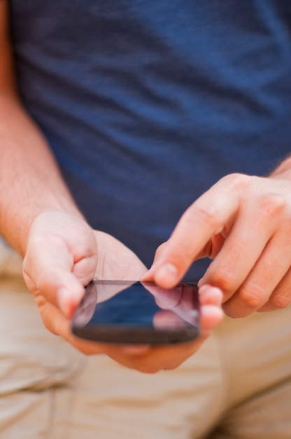 Free Photo close up of a man using mobile smart phone