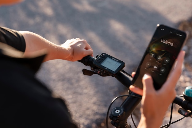 Close up on man using phone while on electric bike