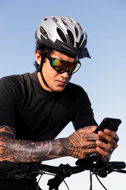 Close up on man using phone while on electric bike