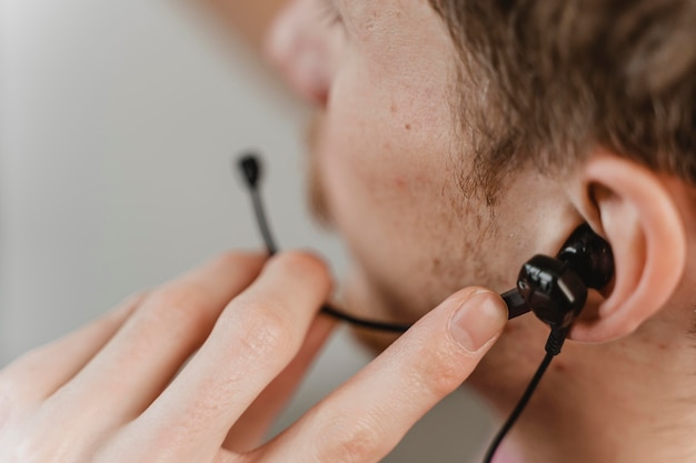 Close-up man wearing earphones