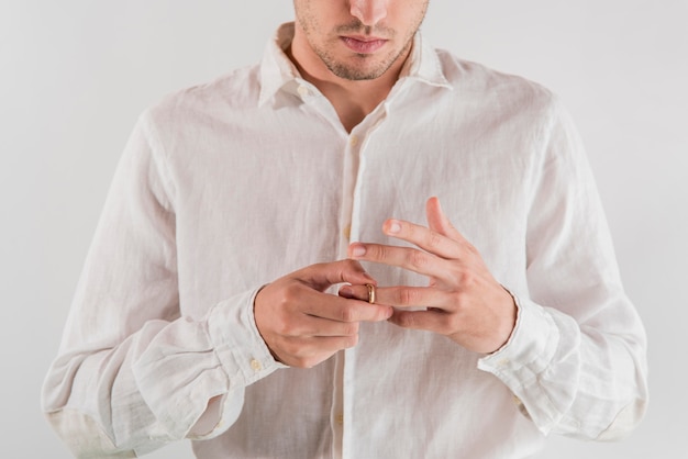 Close-up man with golden wedding ring