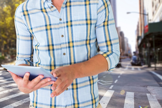 Close-up of man with tablet and city background