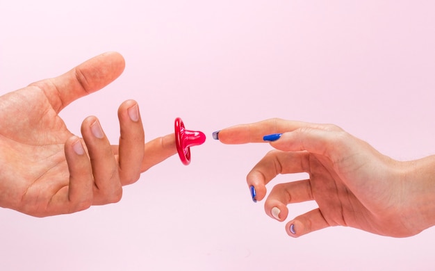 Close-up man and woman hands with condom