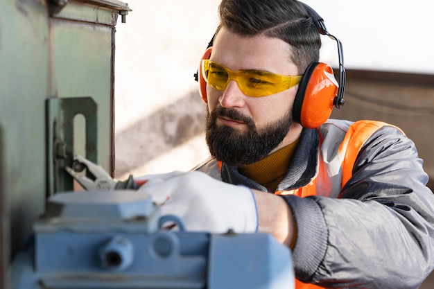 Free Photo close up man working with tool