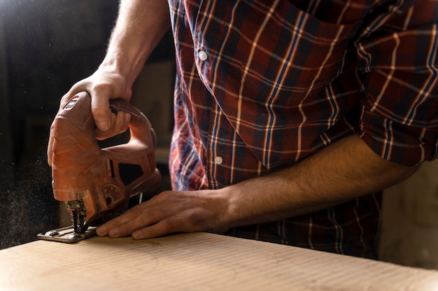 Free Photo close up man working with wood