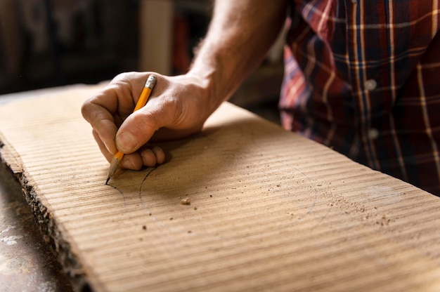 Free Photo close up man working with wood