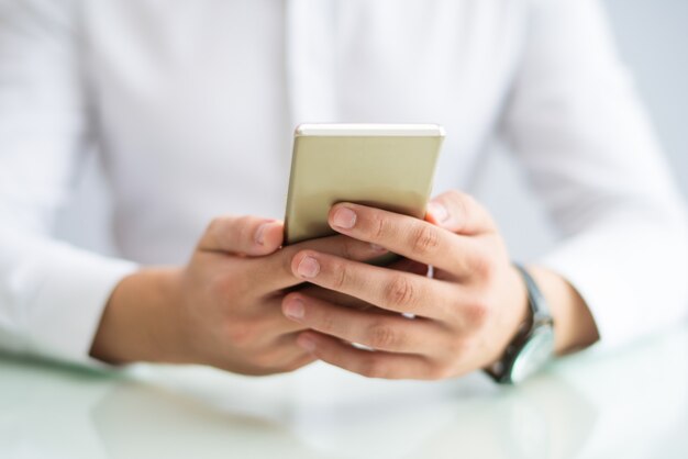 Close-up of manager checking message on phone