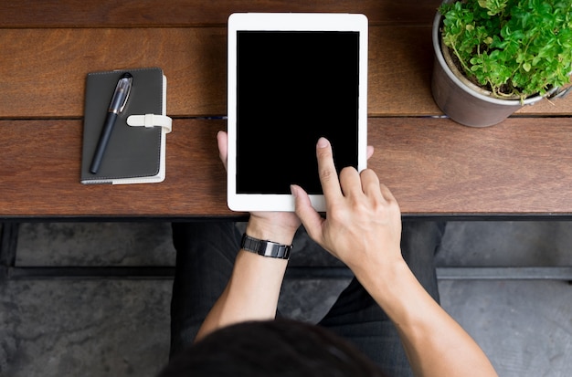 Close up of mans hands using tablet on counter, Image taken from above