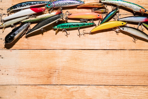 Free photo close-up of many colorful fishing lure on wooden desk